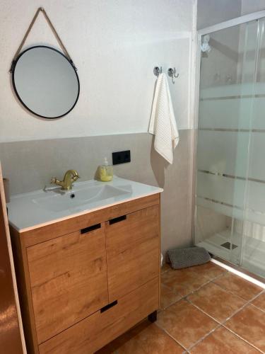 a bathroom with a sink and a shower with a mirror at La Posada De Alanah in Candeleda