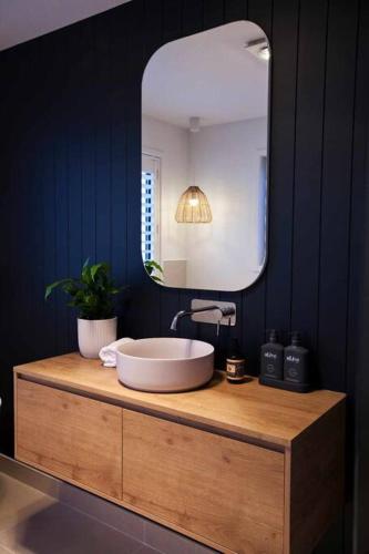 a bathroom with a sink and a mirror at Bruny Island Sunset Retreat in Alonnah