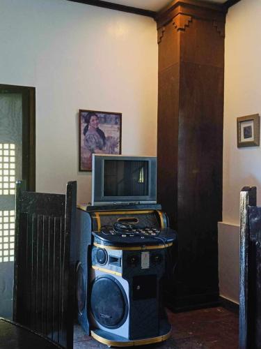 a tv sitting on top of a table with a television at Kavanah Suites Tagaytay- Villa 2 in Tagaytay