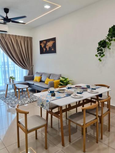 a living room with a couch and a table and chairs at Bayu Temiang Residensi in Seremban