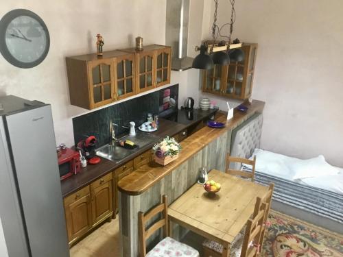 a small kitchen with a table and a sink at Vila Bratocea in Cheia