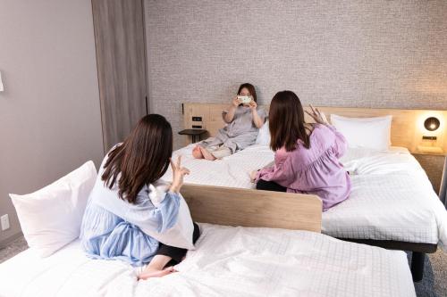 Ένα ή περισσότερα κρεβάτια σε δωμάτιο στο Tokyu Stay Shibuya