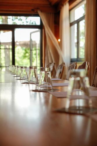 a long table with glasses on it in a room at Hotel-Restaurant Kreuzberghof Tagungs- und Veranstaltungshotel in Tiefenbach