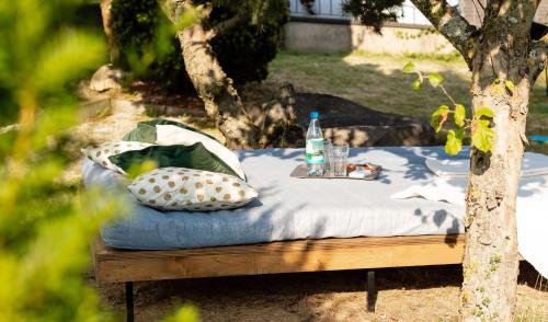 a bed with a bottle of water on top of it at Gemütliche Ferienwohnung & Garten in Sankt Johann