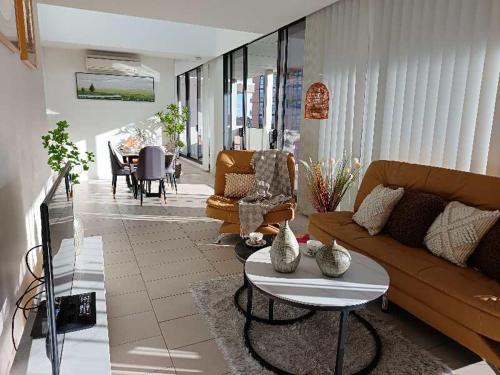 a living room with a couch and a table at Luxury Condo 2Bedrooms near Olympic Park CBD in Sydney
