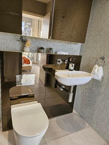 a bathroom with a toilet and a sink at Luxury Condo 2Bedrooms near Olympic Park CBD in Sydney