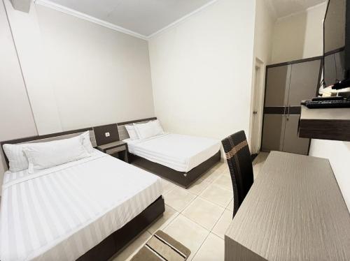 Ένα ή περισσότερα κρεβάτια σε δωμάτιο στο Capital Panorama Guest House Syariah