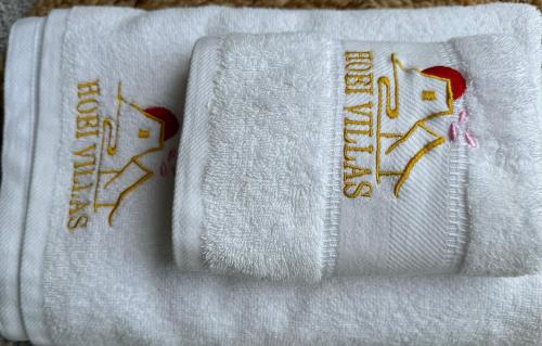 two towels with writing on them on a table at HOEI villas Fujisan全景 富士山 河口湖中心区 in Fujikawaguchiko