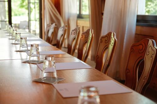 a long row of tables and chairs in a restaurant at Hotel-Restaurant Kreuzberghof Tagungs- und Veranstaltungshotel in Tiefenbach