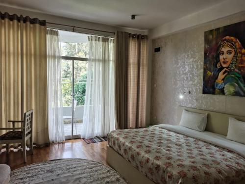 a bedroom with a bed and a painting on the wall at Panorama Green View Hotel Nuwara Eliya in Nuwara Eliya