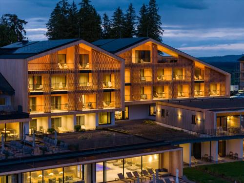 an aerial view of a hotel at night at PANORAMA Allgäu Spa Resort in Seeg