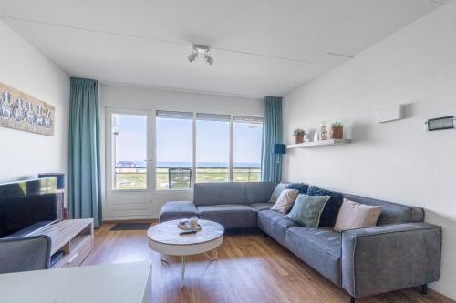 a living room with a couch and a table at Appartementencomplex Juliana 102 in De Koog