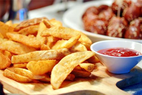 a plate of french fries with a bowl of ketchup at Minyoun Chengdu Dongda Hotel in Chengdu