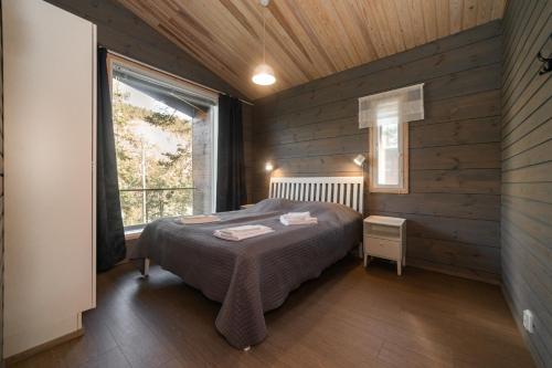 a bedroom with a bed in a room with a window at Villa Fox Ruka in Ruka