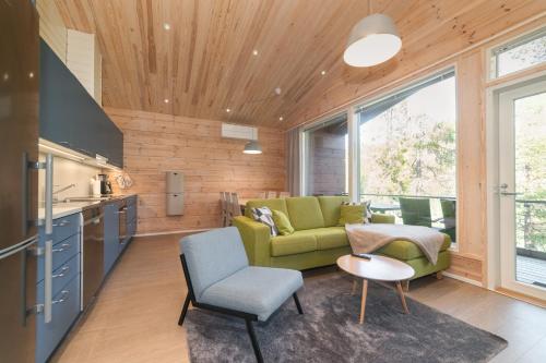 a living room with a green couch and a table at Villa Fox Ruka in Ruka