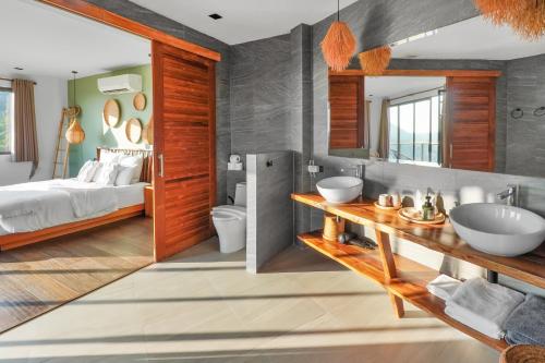 a bathroom with a bed and a sink and a mirror at Mirage Villa in Hinkong