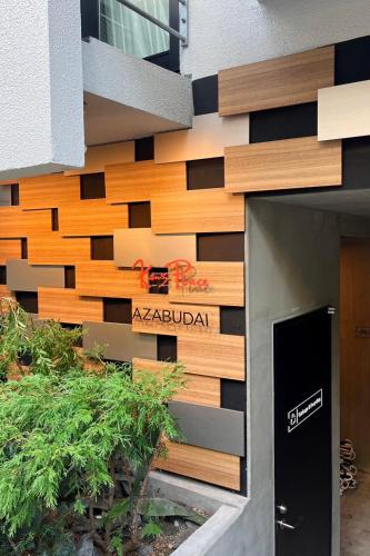 a building with a sign on the side of it at Ken's Place Azabudai in Tokyo