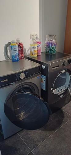 a washing machine with its door open in a room at Maison gîte rural cercle Saint-Joseph Roisin in Roisin