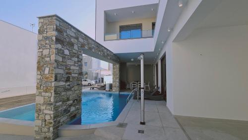 a swimming pool in the middle of a house at STAY Oasis Luxury Villas in Ayia Napa