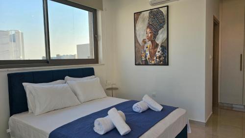 a bedroom with a bed with two towels on it at STAY Oasis Luxury Villas in Ayia Napa