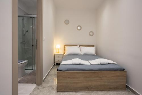 a bedroom with a bed and a walk in shower at Ourania Apartment 2 in Pentati