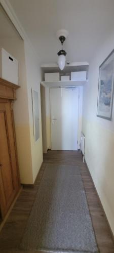 an empty hallway with a white door and a ceiling at Maria Altreichenau in Neureichenau