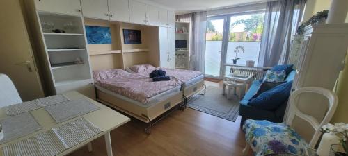 a room with a bed and a table and a couch at Maria Altreichenau in Neureichenau