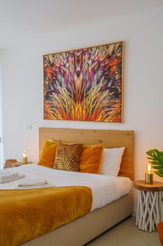 a bedroom with a bed with a painting on the wall at Diamond Villa, luxury house with private pool in Lourinhã