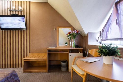 a room with two tables and a desk and a mirror at Hotel Brod - Free Parking in Sofia