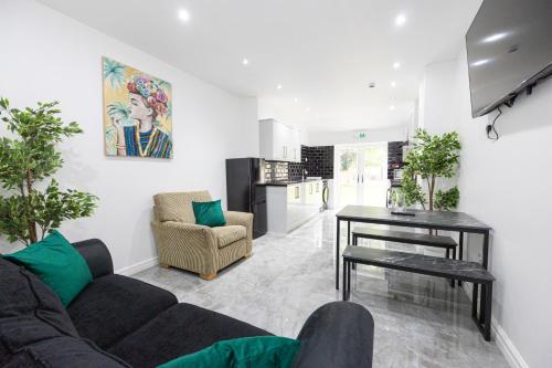 a living room with a couch and a table at The Kent- Luxury Rooms in Manchester