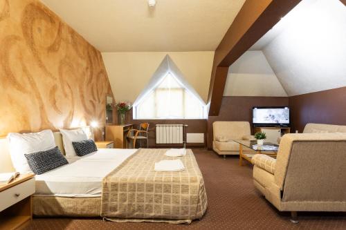 a hotel room with a bed and a window at Hotel Brod - Free Parking in Sofia
