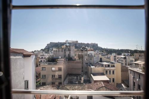 a view of a city from a window at Tempi Hotel in Athens