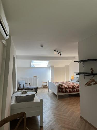 a bedroom with a bed and a couch in a room at Habitat in Momignies