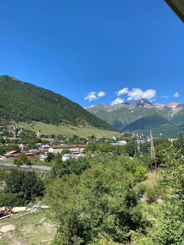 a view of a town with mountains in the background at COTTAGE cozy side in Mestia