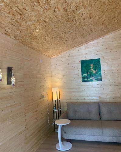 a living room with a couch and a table at COTTAGE cozy side in Mestia