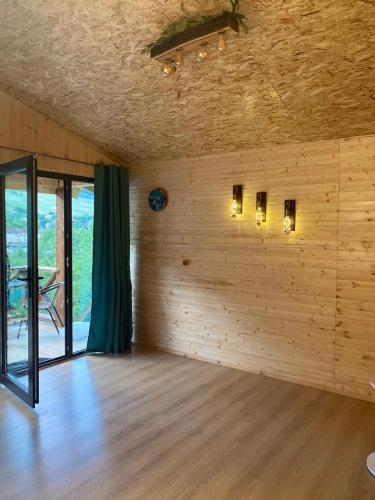 a room with a wooden wall with lights on it at COTTAGE cozy side in Mestia