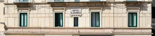a building with a sign on the side of it at Albergo S. Andrea in Amalfi