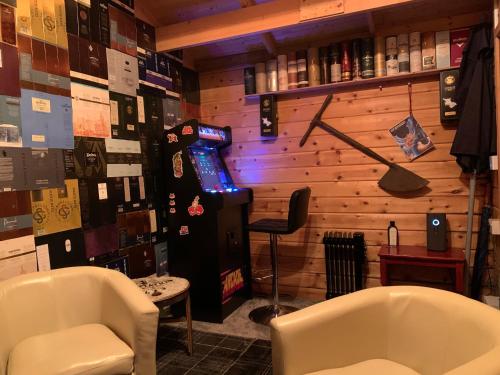a room with two chairs and a video game machine at The Gables Whisky B&B in Dufftown