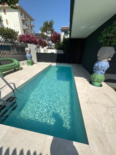 a swimming pool with a teddy bear in the water at Beach Palace with small swimming pool, private beach, parking in Lido di Jesolo