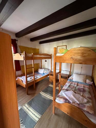 a room with three bunk beds in it at 2 hálószobás vendégház in Balatonboglár