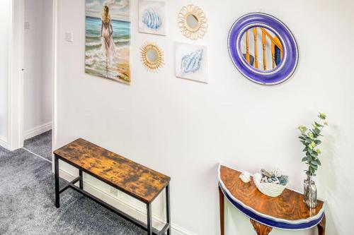 a room with a table and some pictures on the wall at The Lookout, Seaside Getaway in Cleveleys