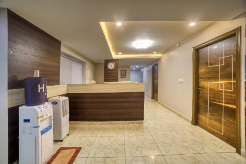 a room with a counter and a clock on the wall at Stay On The Way Transit Hotel in Bengaluru
