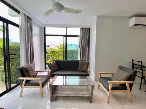 a living room with a couch and two chairs at 360 Degree Kamala Seaview Villa in Kamala Beach