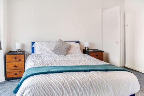 a bedroom with a large bed with two night stands at The Lookout, Seaside Getaway in Cleveleys