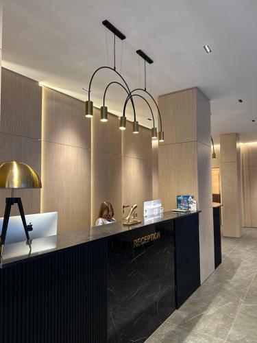 a woman sitting at a counter in an office lobby at DREAM HOTEL SARANDA in Sarandë
