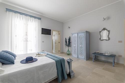 a bedroom with a bed with a hat on it at Le Chiese Azienda Bio Agri Turistica in San Pietro in Lama