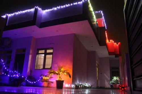 a house with christmas lights on the side of it at Vimegh Homestay in Agra