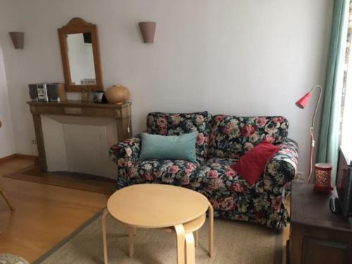 a living room with a couch and a table at Domitine in Besançon