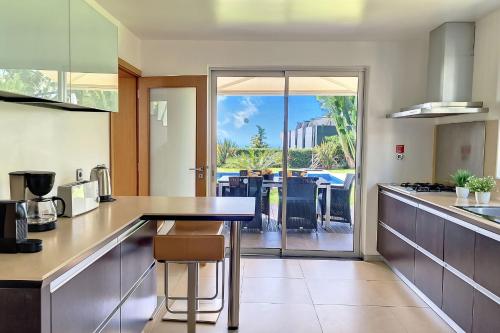 a kitchen with a table and a view of a patio at Villa Ravenala - by LovelyStay in Funchal