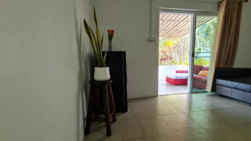a living room with a vase of flowers on a table at Koh Mak Garden View for Family&Friends in Ko Mak